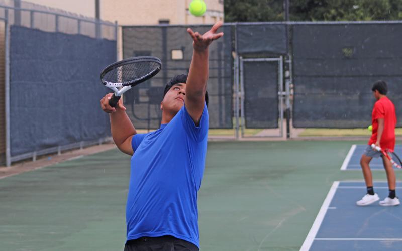 (ALEX HAVARDANKSY | THE GRAHAM LEADER) Chris Reyes throws a ball up in the air for a serve attempt during one of his matches. Reyes was named an academic all-district player for the boys tennis team. 