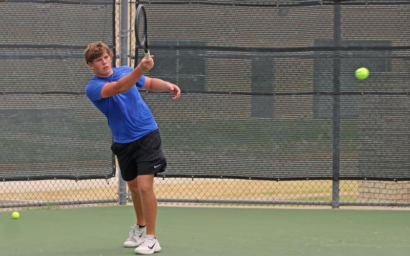 (ALEX HAVARDANSKY | THE GRAHAM LEADER) Tyler Bryan takes a swing on a ball during his singles match Friday, Aug. 1. Bryan used a unique mix of power and quickness to overwhelm opponents.