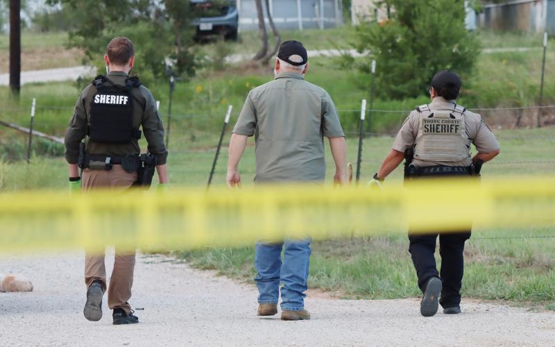 (THOMAS WALLNER | THE GRAHAM LEADER) Young County Sheriff Travis Babcock (center) walks down High Street in Newcastle with deputies where a shooting occurred Sunday, Aug. 17.