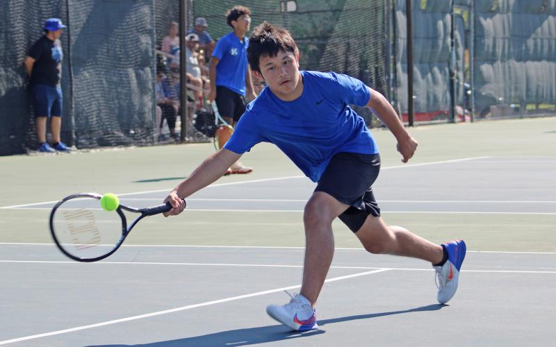 (ALEX HAVARDANSKY | THE GRAHAM LEADER) Brodey Mills gets low to get after a ball Saturday, Aug. 2. Mills flipped the switch in his second mixed doubles match to help pull out a dominant 8-4 win. 