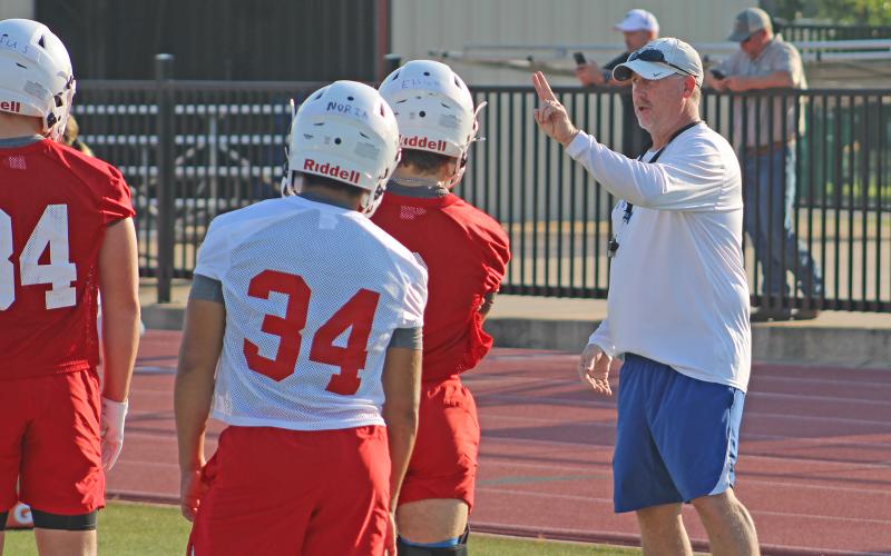 (ALEX HAVARDANSKY | THE GRAHAM LEADER) Steers head coach Clay McChristian instructing his players at two-a-day practices Tuesday, Aug. 5. McChristian said the first couple of practices for the Steers are all about refreshing on the basics.