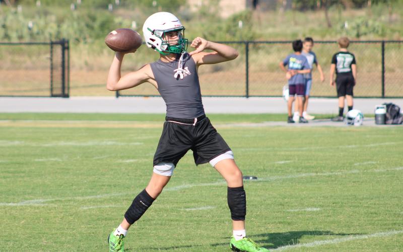 (ALEX HAVARDANSKY | THE GRAHAM LEADER) Newcastle players practice passing at two-a-days Tuesday, Aug. 5. Bobcats head coach Isiah Archer said that for these practices its all about mastering the fundamentals as players will need to be versatile.