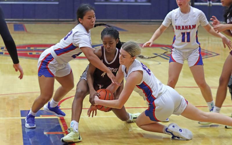 (THOMAS WALLNER | THE GRAHAM LEADER) Fayth Bryer (right) and Rebecca McGregor jump to get possession of the ball during the Lady Blues game Friday, Jan. 31 against Brownwood. Bryer and McGregor were both recognized following the game as seniors in the program.