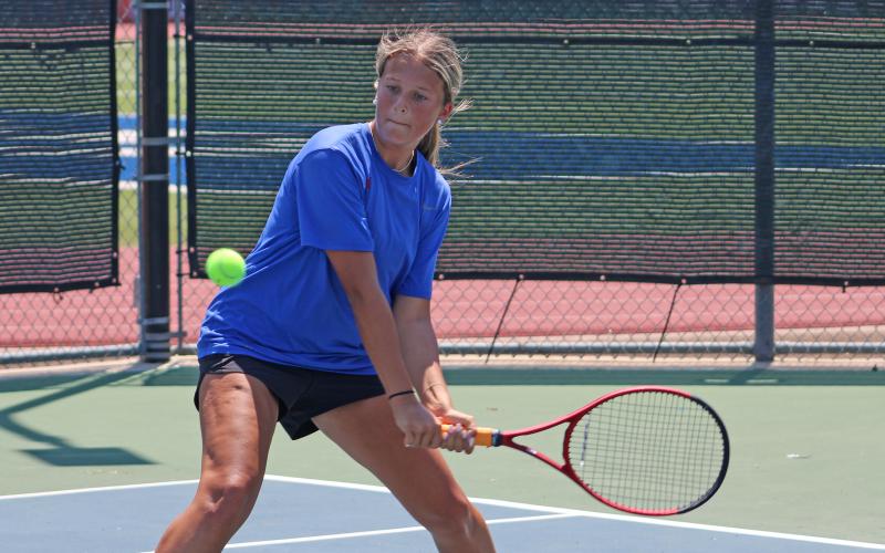 (ALEX HAVARDANSKY | THE GRAHAM LEADER) Kline Krupp makes a two-handed swing on a ball Wednesday, Aug. 6, against Stephenville. Krupp was one of four Lady Blues who picked up a singles victory. 