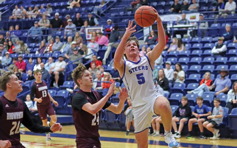(THOMAS WALLNER | THE GRAHAM LEADER) Cooper Corley jumps to make a layup shot during the game against Brownwood held Friday, Jan. 31. Corley contributed 10 points in the game overall.