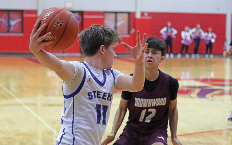 (THOMAS WALLNER | THE GRAHAM LEADER) Cooper Wilde looks for an open teammate during the matchup Friday, Jan. 31 against Brownwood where the Steers came out on top.