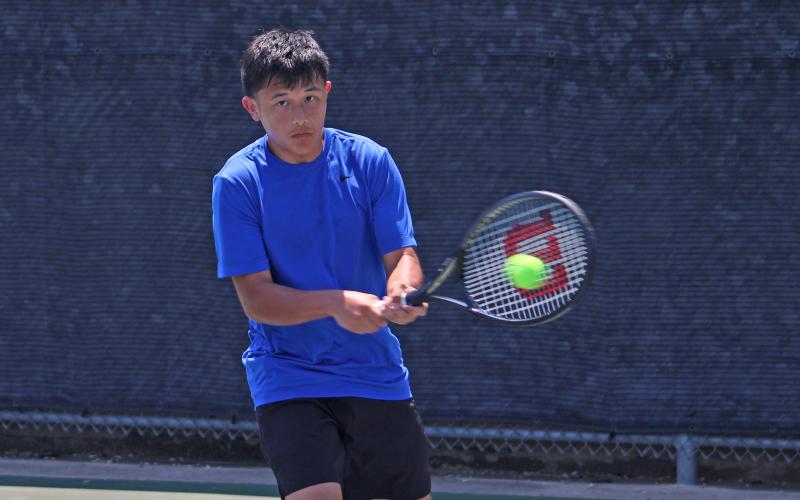 (ALEX HAVARDANSKY | THE GRAHAM LEADER) Brodey Mills makes contact with a ball Wednesday, Aug. 6, against Stephenville. Mills alongside Olivia Buckley picked up an 8-0 mixed doubles match win on the day. 