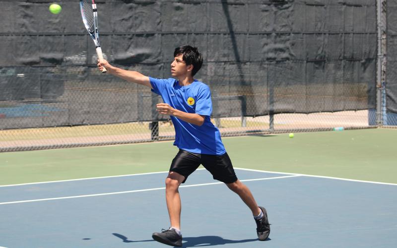(ALEX HAVARDANSKY | THE GRAHAM LEADER) Jordan Miranda takes an overhead swing in his singles match Wednesday, Aug. 6, against Stephenville. Miranda was one of five Steers singles competitors to pick up wins on the day.