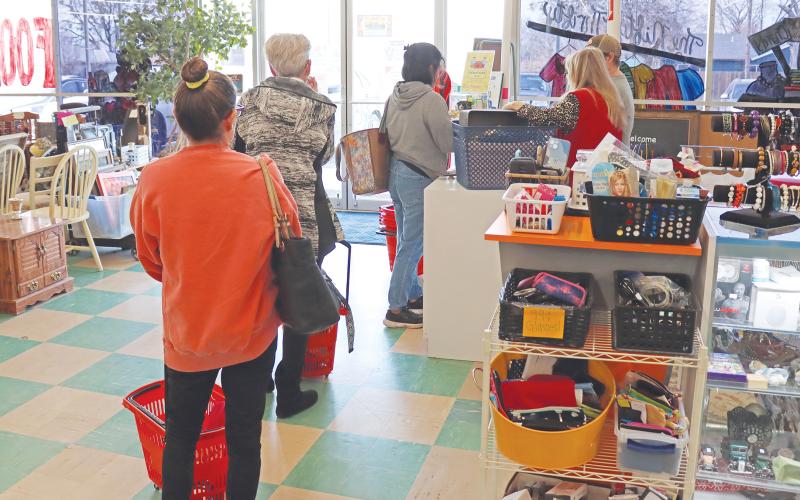 (THOMAS WALLNER | THE GRAHAM LEADER) Visitors to the Nifty Thrifty thrift store in Graham check out Tuesday, Dec. 19 at the counter. The store is one of the organizations which makes up the Graham Crisis Center and what helps to fund its efforts.