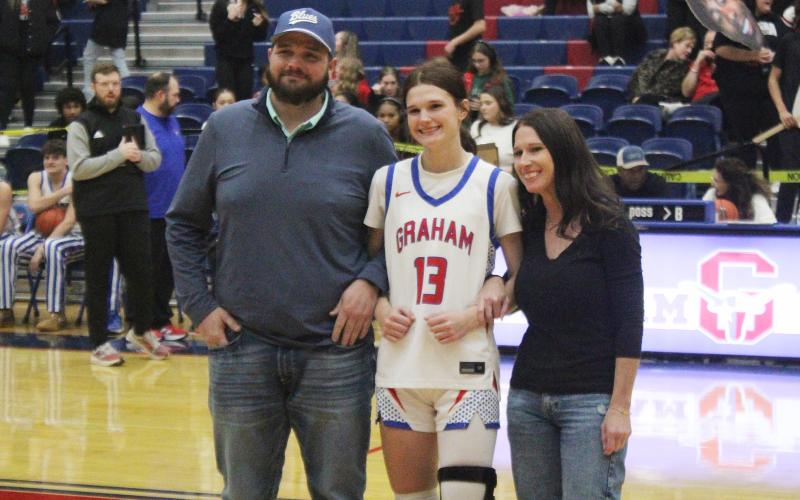 (ALEX HAVARDANSKY | THE GRAHAM LEADER) Tara Dawson stands with her family Tuesday, Feb. 10 on senior night. The Lady Blues were able to send Dawson off on a high note with a 45-35 victory. 