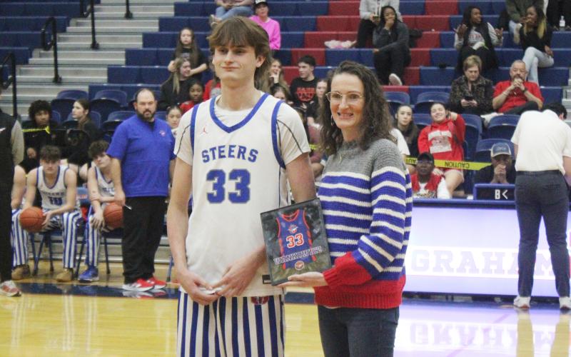 (ALEX HAVARDANSKY | THE GRAHAM LEADER) Nick Wankowicz stands with his mother Tuesday, Feb. 10 on Senior Night. The Steers were able to send Wankowicz off with a 58-37 win over the Mineral Wells Rams.