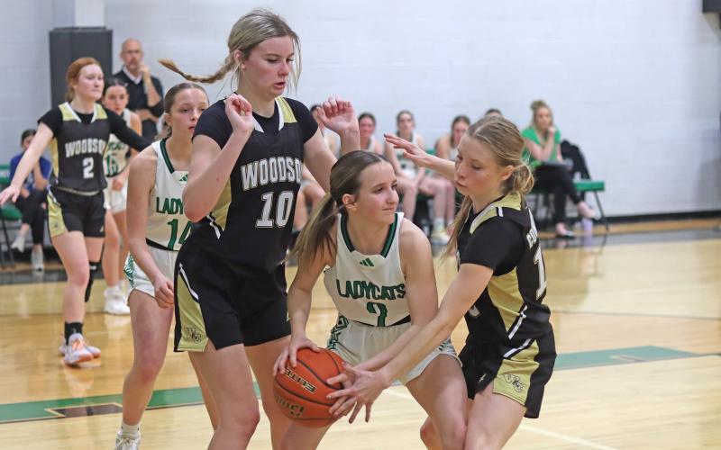 (THOMAS WALLNER | THE GRAHAM LEADER) Kinsey Hawkins struggles with Woodson defenders during the game Tuesday, Feb. 4. Hawkins brought the only 3-point shots in the second half of the game.