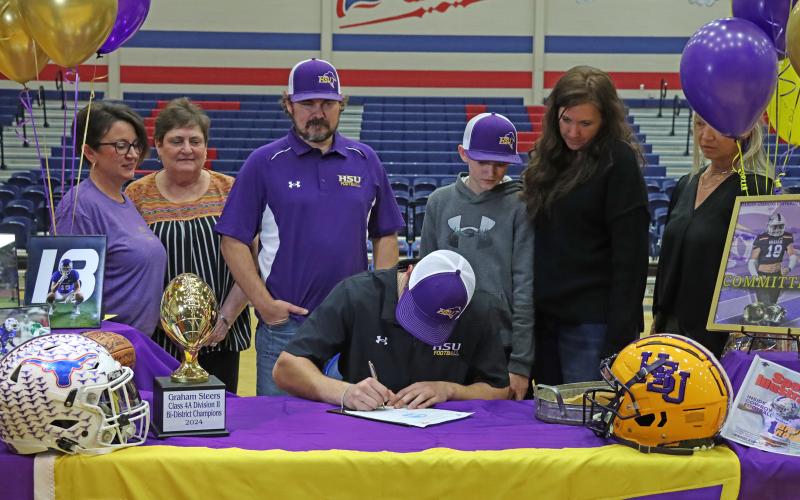 (THOMAS WALLNER | THE GRAHAM LEADER) Brycen Rogers signs to play football for Hardin-Simmons University during a Graham High School athletes signing ceremony Wednesday, Feb. 5.
