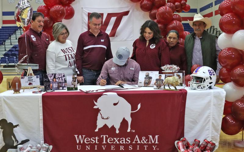 (THOMAS WALLNER | THE GRAHAM LEADER) Ozzy Trejo signs to play football for West Texas A&M University during a Graham High School athletes signing ceremony Wednesday, Feb. 5.