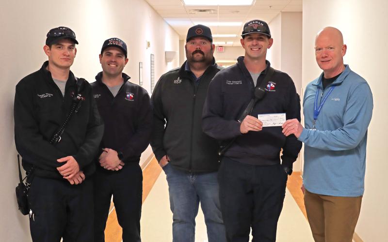 (THOMAS WALLNER | THE GRAHAM LEADER) Members of Graham Fire Department presented a check Tuesday, Jan. 2 for $1,000 to Graham Regional Medical Center to be used for local breast cancer patients. Shown from left to right are Brandon Thomas, Cole Carlin, Daniel Webb, Cole Epperson and Shane Kernell. 