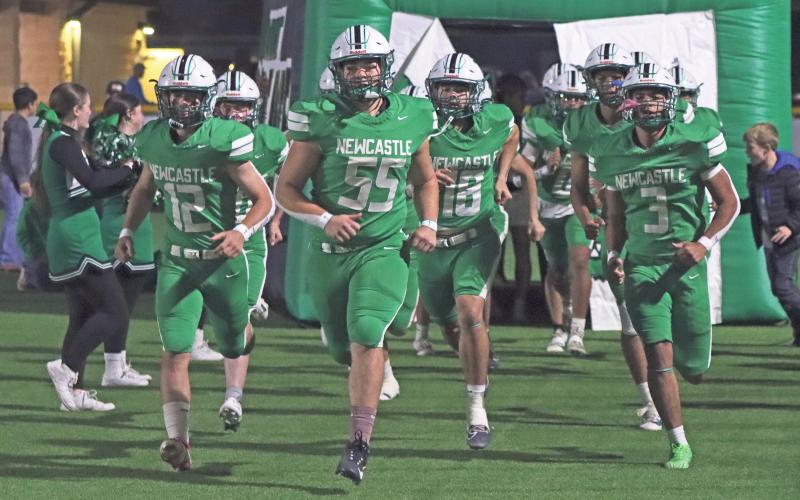 (ARCHIVE PHOTO | THE GRAHAM LEADER) The Newcastle Bobcats march onto the field Friday, Nov. 22, 2024, against Westbrook in their area playoff matchup. The Bobcats football team along with several other Newcastle fall athletic teams will be presented at the meet the Bobcats booster bash event.