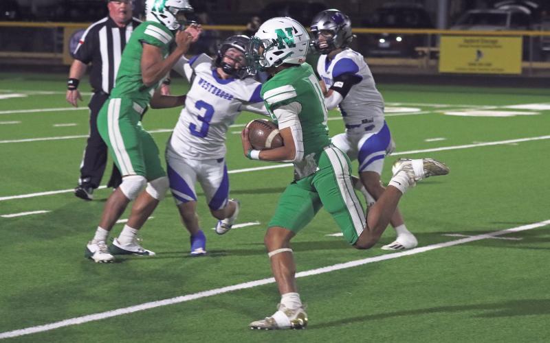 (ARCHIVE PHOTO | THE GRAHAM LEADER) The Bobcats’ London Martinez sprints with the ball past Westbrook defenders on his way to a touchdown Friday, Nov. 22 in Newcastle’s 98-52 loss to the Wildcats. Martinez was named District Offensive MVP and First Team All-District as a safety on defense.