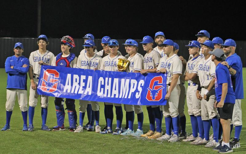 (ALEX HAVARDANKSY | THE GRAHAM LEADER)  The Graham Steers hold their area champs banner and trophy Friday, May 9. The Steers defeated the FW Castleberry Lions 7-3 in the second round. 