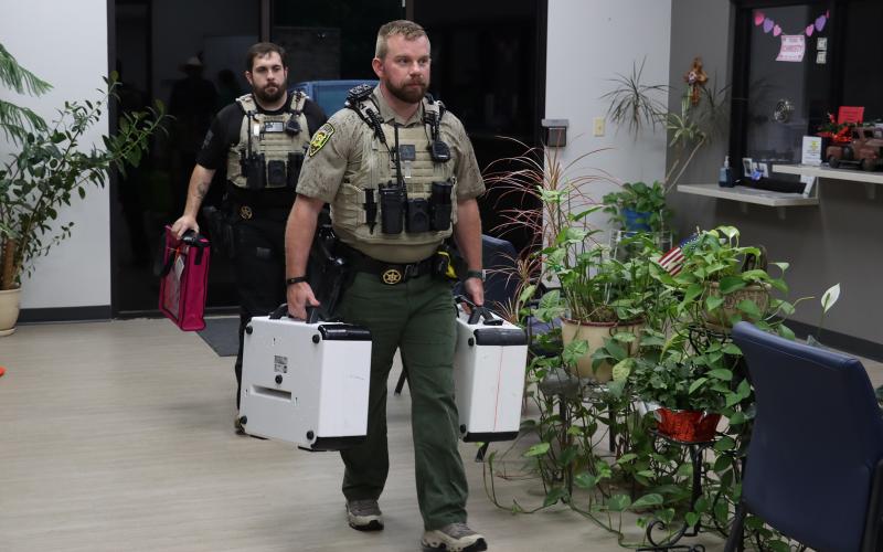 (THOMAS WALLNER | THE GRAHAM LEADER) Young County deputies carry in voting machines to the Young County Annex following the conclusion of voting Tuesday, May 26.