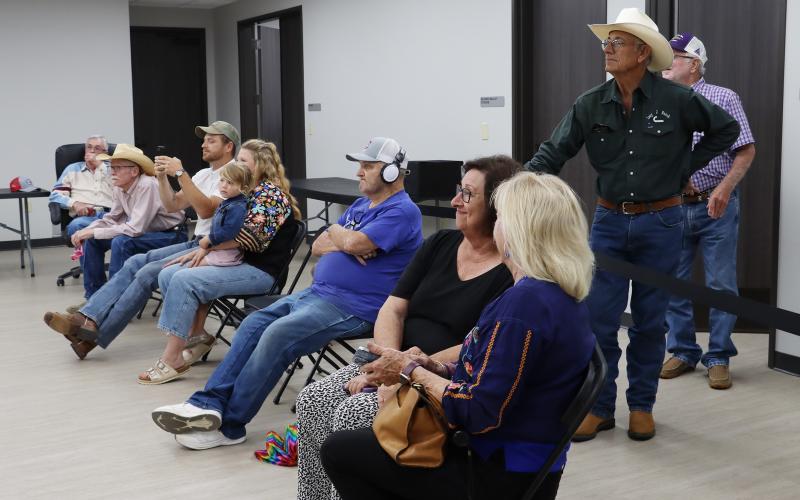 (THOMAS WALLNER | THE GRAHAM LEADER) Visitors at the Young County Annex take pictures of the results as they are displayed by the Young County Elections Administrator following the conclusion of voting Tuesday, May 26 in the primary runoff election.