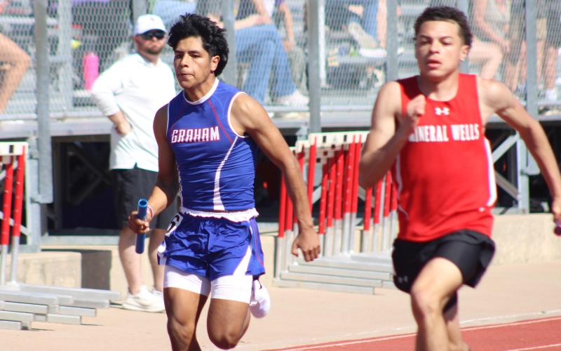 (ALEX HAVARDANSKY | THE GRAHAM LEADER) Santiago Zamora races to the finish line in the 4x100 meter relay at the Ram Relays. The Steers finished sixth in the event in their season opener Friday, Feb. 27. 