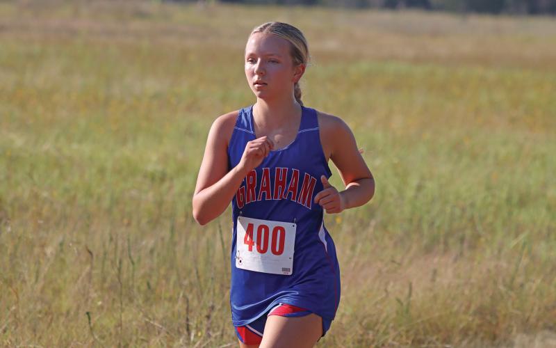 (KYLIE BAILEY | THE GRAHAM LEADER) Anzley Howard makes her way around the course at the Glen Rose Invitational. Howard finished 58 in the two mile run Wednesday, Sept. 10. 