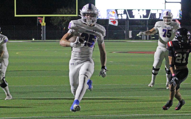 (ALEX HAVARDANSKY | THE GRAHAM LEADER) Colt Taylor leaps into the endzone for the rushing touchdown Thursday, Oct. 23, against the Mineral Wells Rams. Taylor had both a rushing and a receiving touchdown in the team’s victory over Mineral Wells. 
