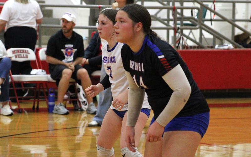 (ALEX HAVARDANKSY | THE GRAHAM LEADER) Makenzie Vacante, 7, and Hudson Wright, 14, prepare for a serve receive attempt Friday, Oct. 24, against the Mineral Wells Lady Rams.