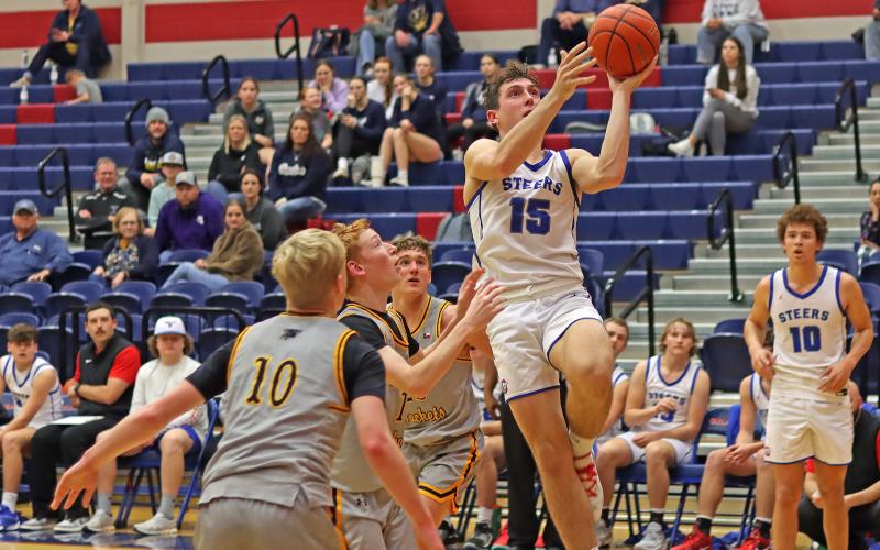(THOMAS WALLNER | THE GRAHAM LEADER) Graham’s Ty Thompson (15) puts up a layup past Stephenville defenders during a game between the two teams Friday, Jan. 26. The Steers fought hard but lost 45-39.