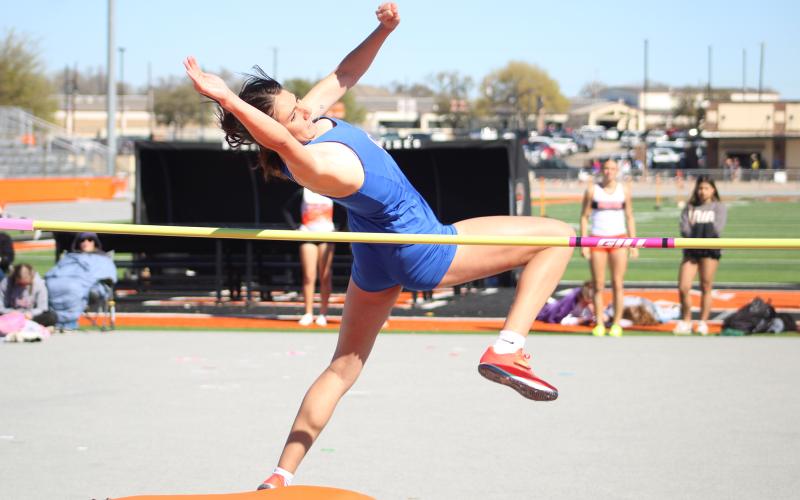 (ALEX HAVARDANSKY | THE GRAHAM LEADER) Emerie Stogner leaps over the pole in the high jump Thursday, March 12. Stogner won the high jump event at the Brad Legan Family and Friends Invitational.