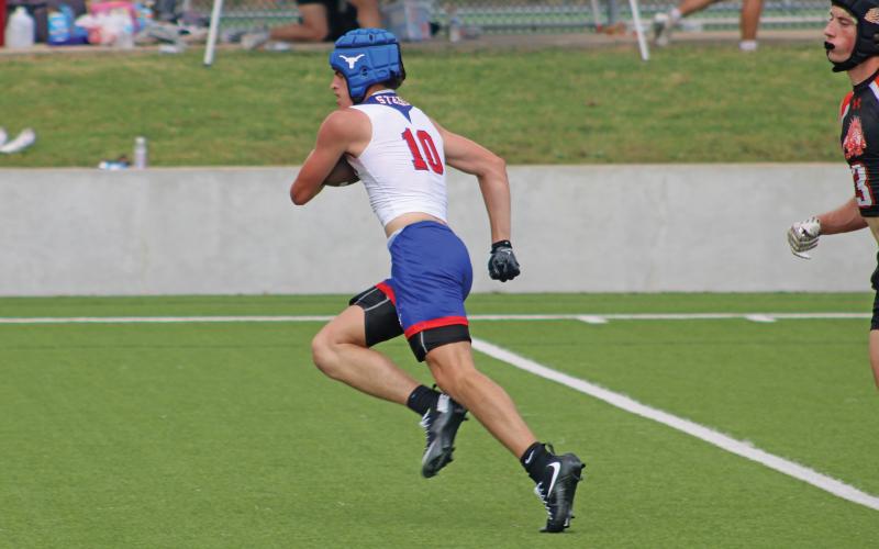 (ALEX HAVARDANSKY | THE GRAHAM LEADER) Brodie Martin sprints away after making a big contested catch over the middle of the field for a touchdown Saturday, May 17. Martin also had a multiple touchdown game against the Lake Worth Bullfrogs later in the day.