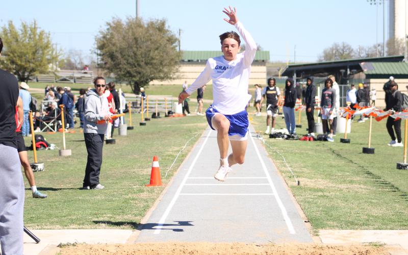 (ALEX HAVARDANSKY | THE GRAHAM LEADER) Nolan Wankowicz leaps in the jumping events Thursday, March 12. Wankowicz finished ninth in the triple jump at the Brad Legan Family and Friends Invitational.