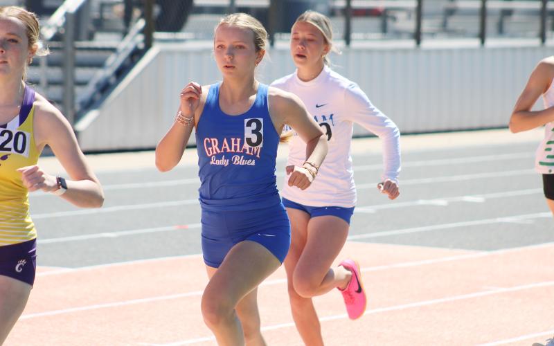 (ALEX HAVARDANSKY | THE GRAHAM LEADER) Ellie Weatherman runs around the track Thursday, March 12. Graham’s four teams finished in the top six at the Brad Legan Family and Friends Invitational. 