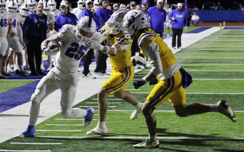 (ALEX HAVARDANSKY | THE GRAHAM LEADER) Colt Taylor runs the ball to the sideline while stiff arming defenders Friday, Oct. 31 against the Brock Eagles. Taylor and Dylan Cox were the primary runners in the backfield in the Steers loss to Brock.