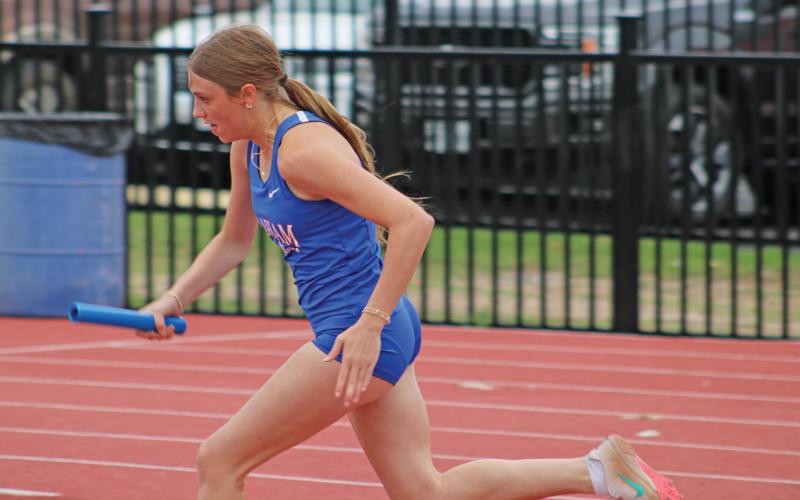 (ALEX HAVARDANSKY | THE GRAHAM LEADER) Katie McGehee puts the Graham relay team off to a solid start Thursday, April 3 in the 4X400 Meter Relay. McGehee’s effort helped the relay team advance to area.