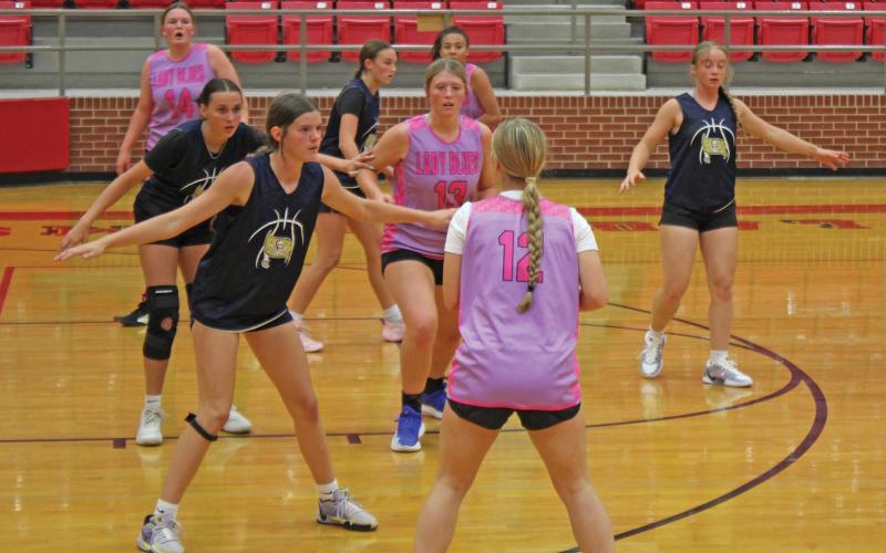 (ALEX HAVARDANSKY | THE GRAHAM LEADER) Adi Pinkston looks to pass to an available player Tuesday, May 20. In game one the Lady Blues beat the Lady Pirates 41-13 in a dominant performance.