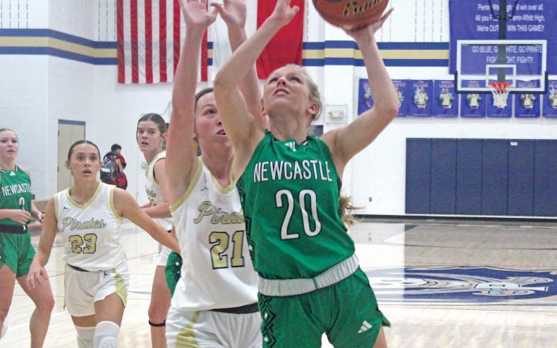 (BRIAN SMITH | JACKSBORO HERALD-GAZETTE) Catherine Youngblood beats a Perrin defender to the basket during Newcastle’s game with Perrin. Youngblood tossed in 12 points to help the Ladycats take a 55-33 win and remain perfect in district. 