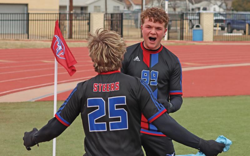 (THOMAS WALLNER | THE GRAHAM LEADER) Jace Gill celebrates with Easton Hedge after Hedge made a goal for the Steers during the first half of the game Friday, Feb. 21 against Bridgeport. The Steers rallied to tie the game, but fell in a penalty shootout. 