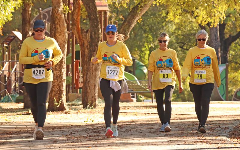 (ARCHIVE PHOTO | THE GRAHAM LEADER) A group of runners decked out in 10th anniversary Spivey Hill Challenge shirts approach the finish line at Firemen’s Park during the 2024 race. The race this year will take place Saturday, Nov. 8 benefiting two area nonprofit organizations.