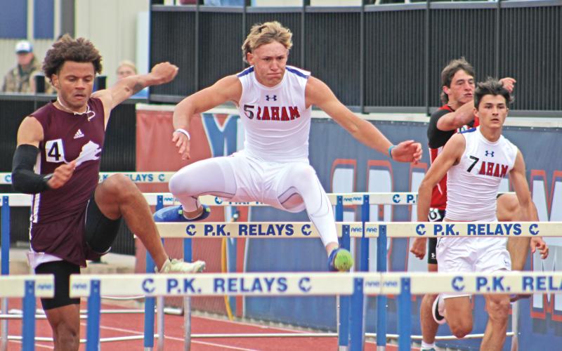 (ALEX HAVARDANSKY | THE GRAHAM LEADER) The Steers varsity track team competes in the 110 meter hurdles at district Thursday, April 3. The track and field teams had impressive performances throughout the days of the event.