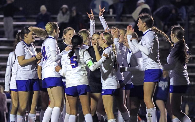 (KYLIE BAILEY | THE GRAHAM LEADER) The Lady Blues celebrate Tuesday, Feb. 10 on the field after defeating the Lady Eagles 5-4. With this win, the Lady Blues improve to 3-0 in district and take first place.