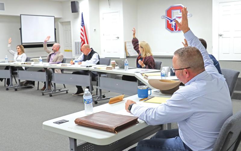 (THOMAS WALLNER | THE GRAHAM LEADER) Members of the Graham ISD Board of Trustees raise their hands to approve the contract for Dr. Mary Johnston as the new superintendent for the district. The board named Johnston as the lone finalist Wednesday, Oct. 23 during a special-called meeting.