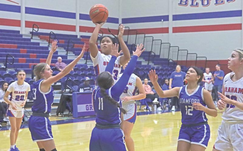 (TC GORDON | THE GRAHAM LEADER) Rebecca McGregor shoots a contested mid-range shot over the outstretched arms of multiple Stamford defenders Tuesday, Nov. 19 during Graham’s 45-35 win.