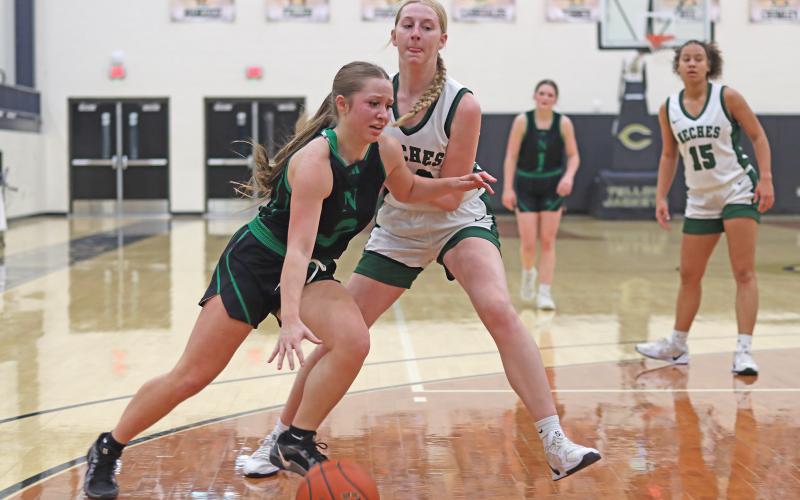 (THOMAS WALLNER | THE GRAHAM LEADER) Kenna Mahan attempts to break past the Neches defense to make a shot during the regional final game Friday, Feb. 21. Mahan helped to bring the team within four points near the end of the game.