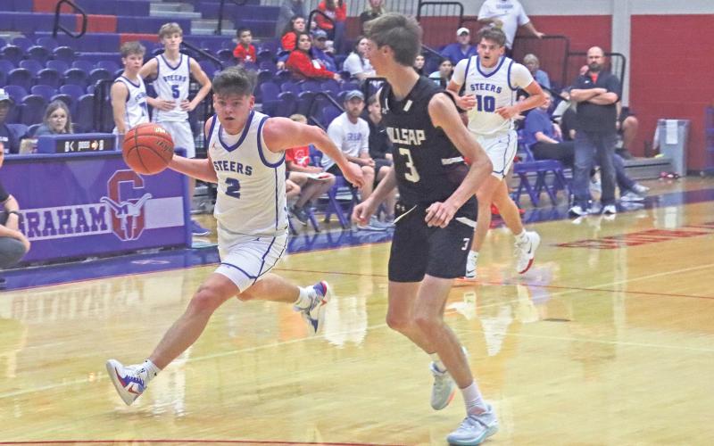 (TC GORDON | THE GRAHAM LEADER) Steers guard Bryce Martin drives to the hoop past a Millsap defender Tuesday, Nov. 19 during Graham’s 51-40 win over the Bulldogs in the first game of the season.