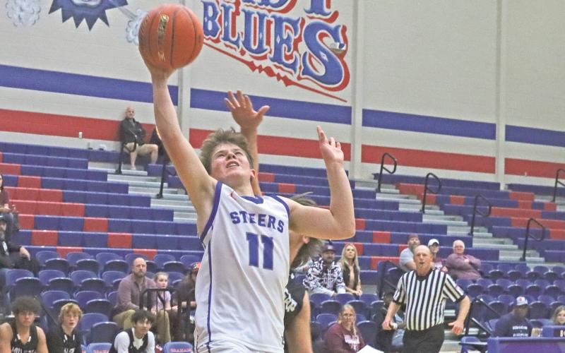 (TC GORDON | THE GRAHAM LEADER) The Steers’ Cooper Wilde gets fouled as he puts up a layup attempt early in the game Tuesday, Nov. 19 in Graham’s season-opening 51-40 win against Millsap.