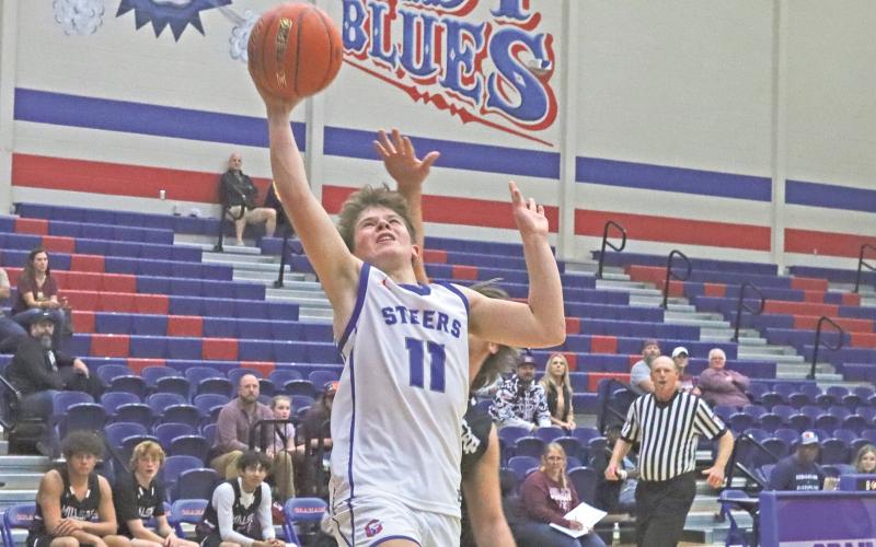 (ARCHIVE PHOTO | THE GRAHAM LEADER) The Steers’ Cooper Wilde gets fouled as he puts up a layup attempt at a game earlier in the season. The Steers came back to secure a 55-54 win Tuesday, Dec. 17 over the Iowa Parks Hawks. 