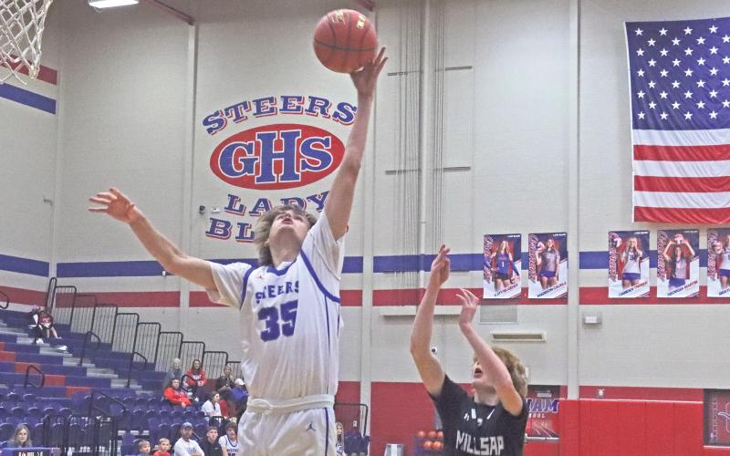 (TC GORDON | THE GRAHAM LEADER) Graham’s Nik Wankowicz uses his length to haul in a rebound in the first half of the team’s first win of the season Tuesday, Nov. 19, a 51-40 victory over Millsap.