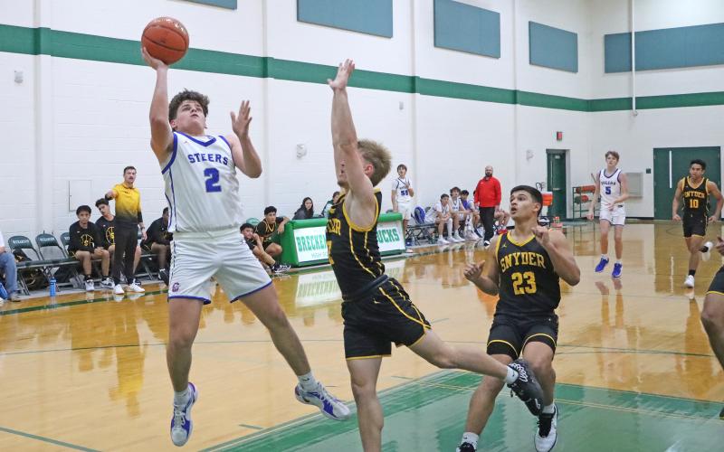 (TC GORDON | THE GRAHAM LEADER) Steers sophomore Bryce Marin leans back to set up a shot over Snyder players during the Breckenridge tournament held from Thursday, Dec. 5 through Saturday, Dec. 7. 