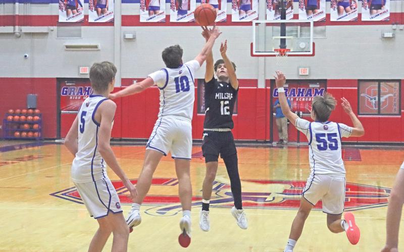 (TC GORDON | THE GRAHAM LEADER) Brodie Martin closes out on a Millsap shooter and gets a finger on the ball for a block Tuesday, Nov. 19 in Graham’s 51-40 win over the Bulldogs.